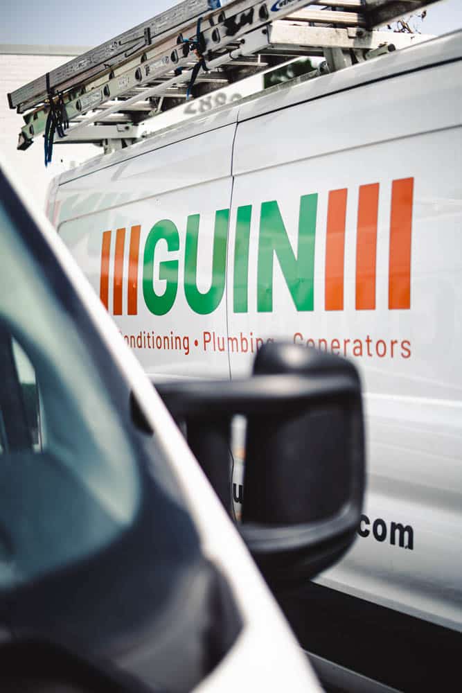 Guin service van with ladders, focusing on HVAC, plumbing, generators.